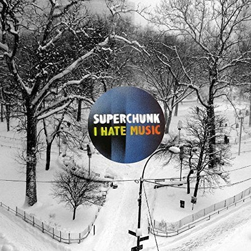 A circular blue logo with Superchunk I Hate Music text over a snowy park.