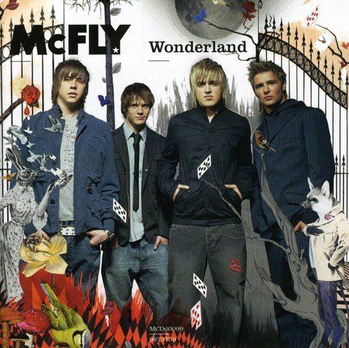 McFly band members posed in front of a surreal, ornate garden gate.