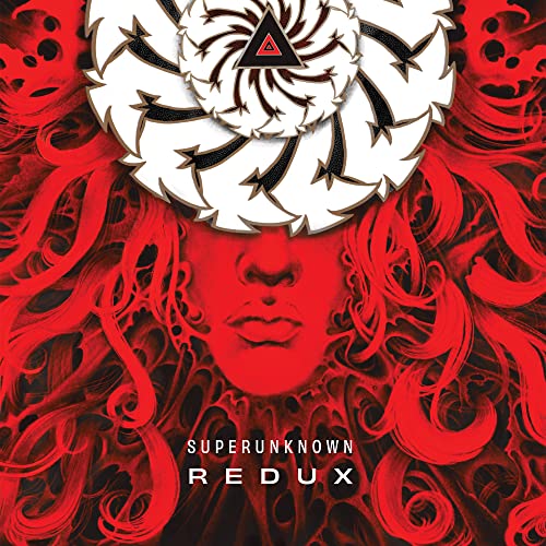 Red album cover featuring a red face with swirling white and black design.