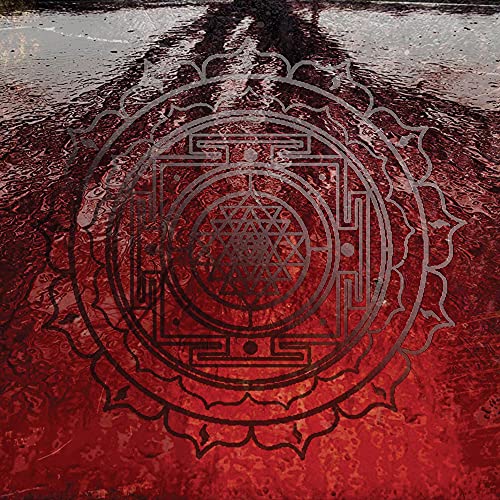 Red and silver geometric design resembling a mandala or sacred symbol.
