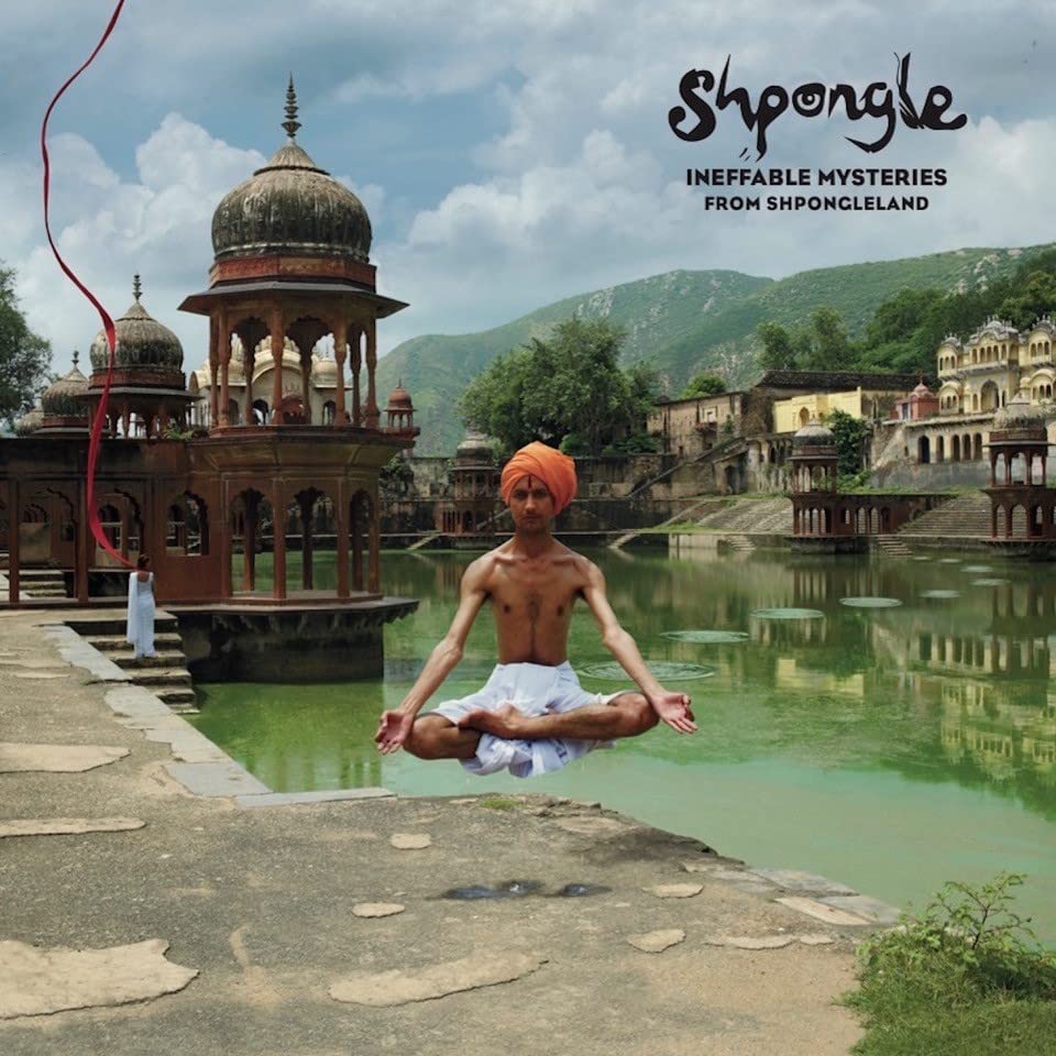 Man levitates in lotus position before ornate Indian palaces.