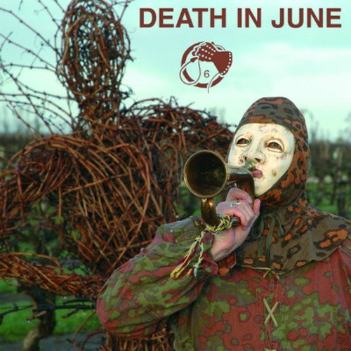 CD cover: masked figure with a trumpet, wicker man in background.