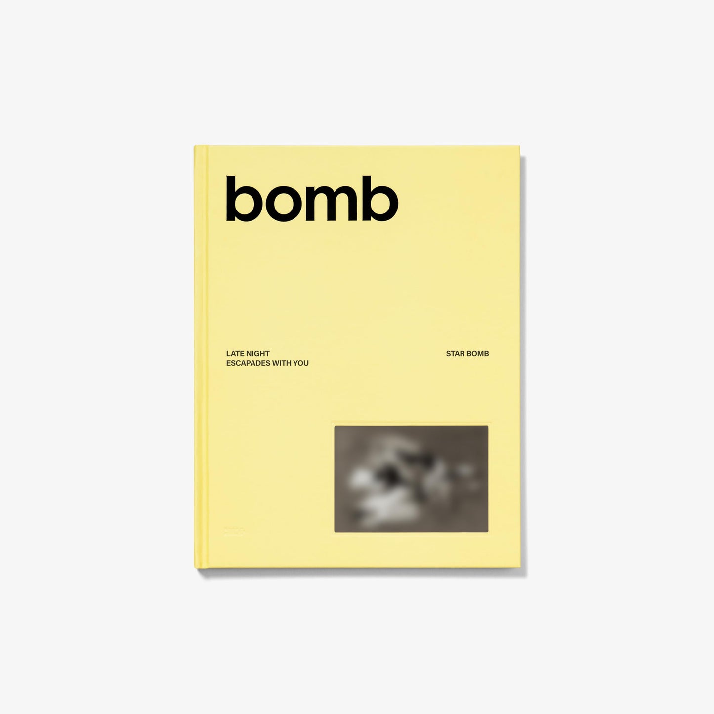 Yellow CD case for ILLIT’s “bomb” album with blurry photo.