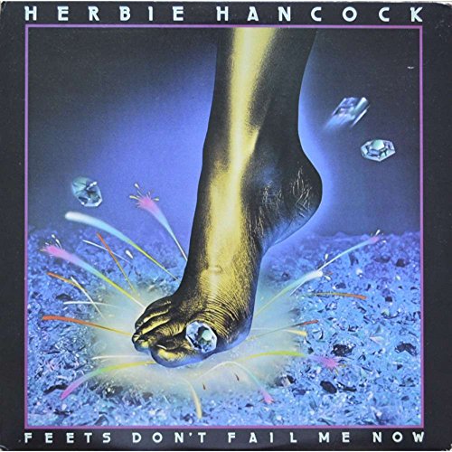 Album cover: a golden foot stepping on shattered glass and gems.