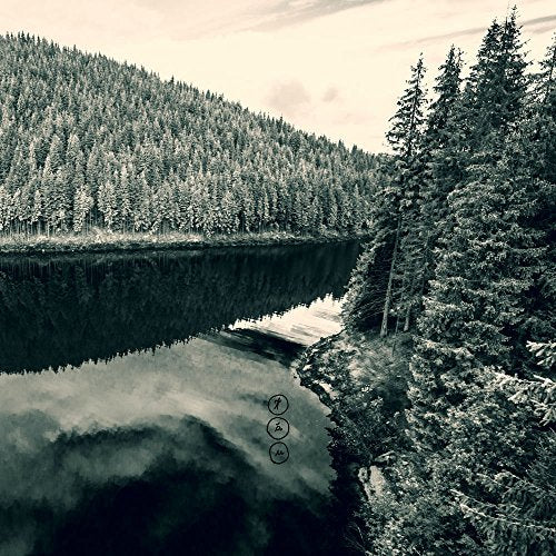 Black and white landscape with trees reflected in water, album cover.