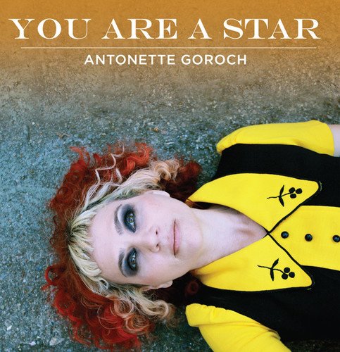 Antonette Goroch album cover: woman with red hair lying on pavement.