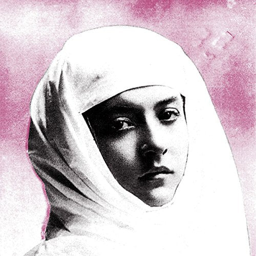 Black and white portrait of a person in a head covering, pink background.