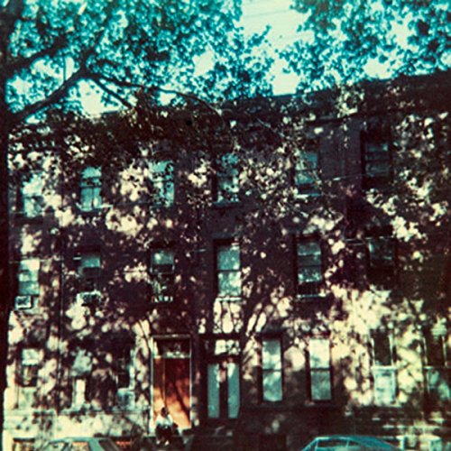 CD cover with a faded, sun-dappled image of a brick building.