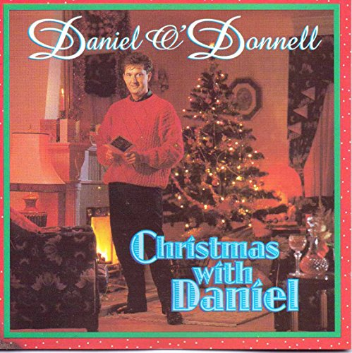 CD cover: Daniel O’Donnell in a red sweater by a Christmas tree.