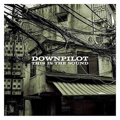CD cover for Downpilot’s “This Is The Sound,” showing tangled wires and buildings.