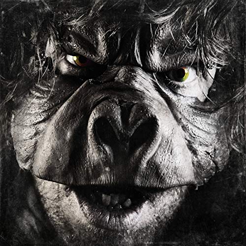 Close-up of a monstrous, gorilla-like face with glowing yellow eyes.