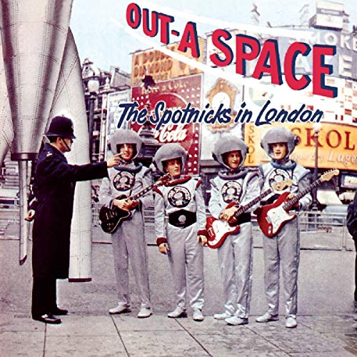 Band in silver spacesuits with guitars, London backdrop, police officer.