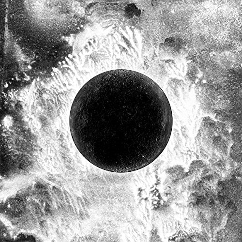Black circle centered on a textured, grayscale abstract background.