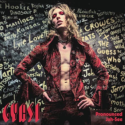 CD cover featuring a man with long hair in a red jacket, text background.