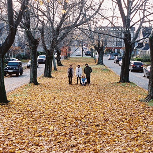Album cover: people standing on a leaf-covered street lined with trees.