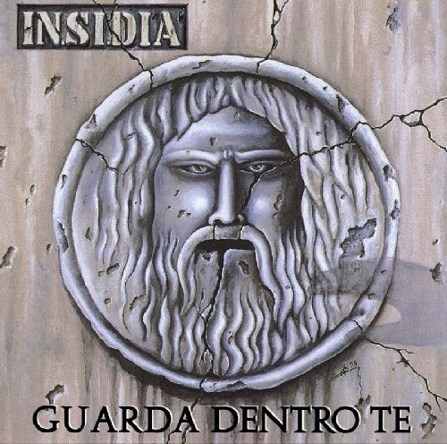 CD cover: weathered stone face with cracks, text "Guarda Dentro Te".