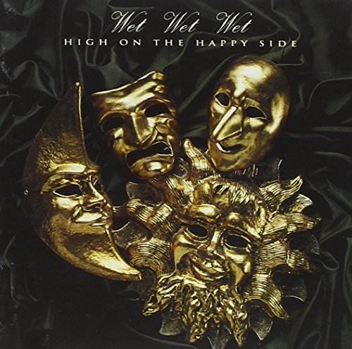 CD cover: Wet Wet Wet album with gold masks on black fabric.