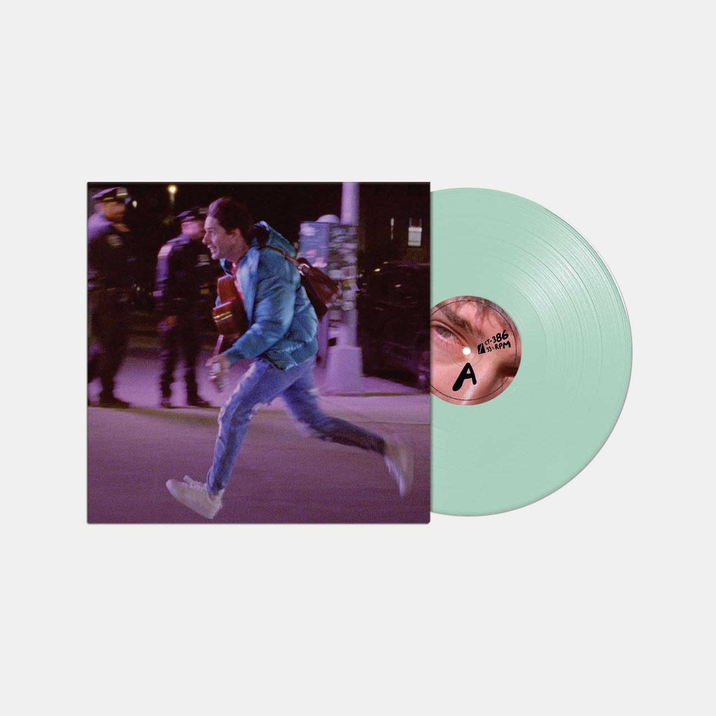 Vinyl record with green tint and album cover featuring a running man.