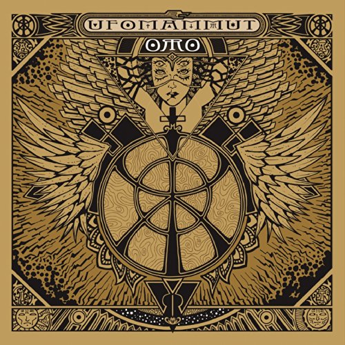Golden album cover with a winged face and circular, geometric design.