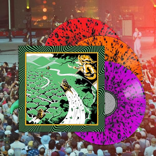 King Gizzard vinyl records with colorful splatter patterns and concert backdrop.