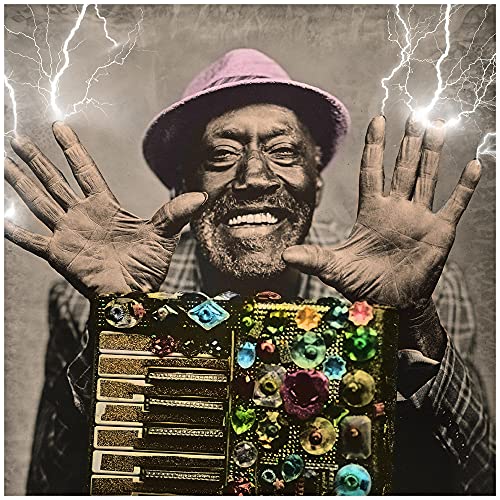Man with raised hands and decorated instrument, lightning background.
