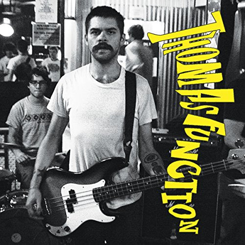Black and white album cover featuring a musician playing a bass guitar.