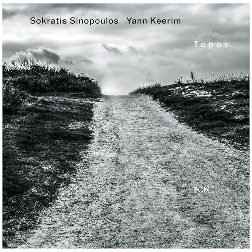 Black and white album cover featuring a dirt road under a cloudy sky.