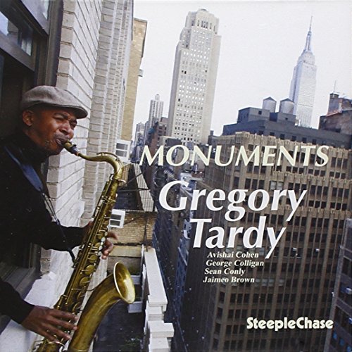 Gregory Tardy plays saxophone on a rooftop with a city skyline.