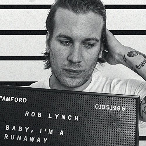 Black and white portrait of Rob Lynch resembling a mugshot.