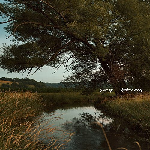 Album cover: landscape with trees, field, and water reflection.