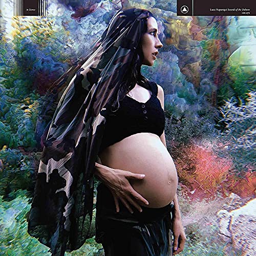 Pregnant woman in camouflage veil, holding her belly, colorful background.
