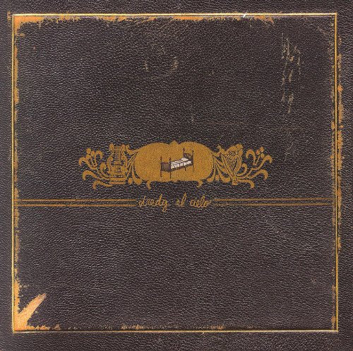 Dark album cover with gold ornate design and a bed illustration.
