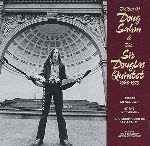 CD cover: Doug Sahm with band instruments, standing in front of a building.