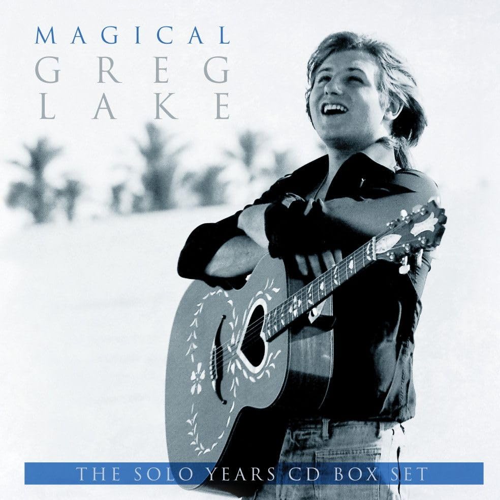 Blue-tinted photoS photo of Greg Lake smiling and holding an acoustic guitar.
