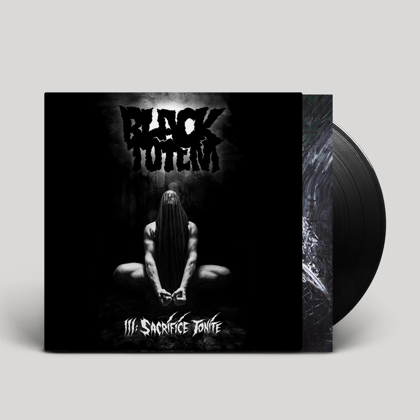 Vinyl record with album cover depicting a cloaked figure in darkness.