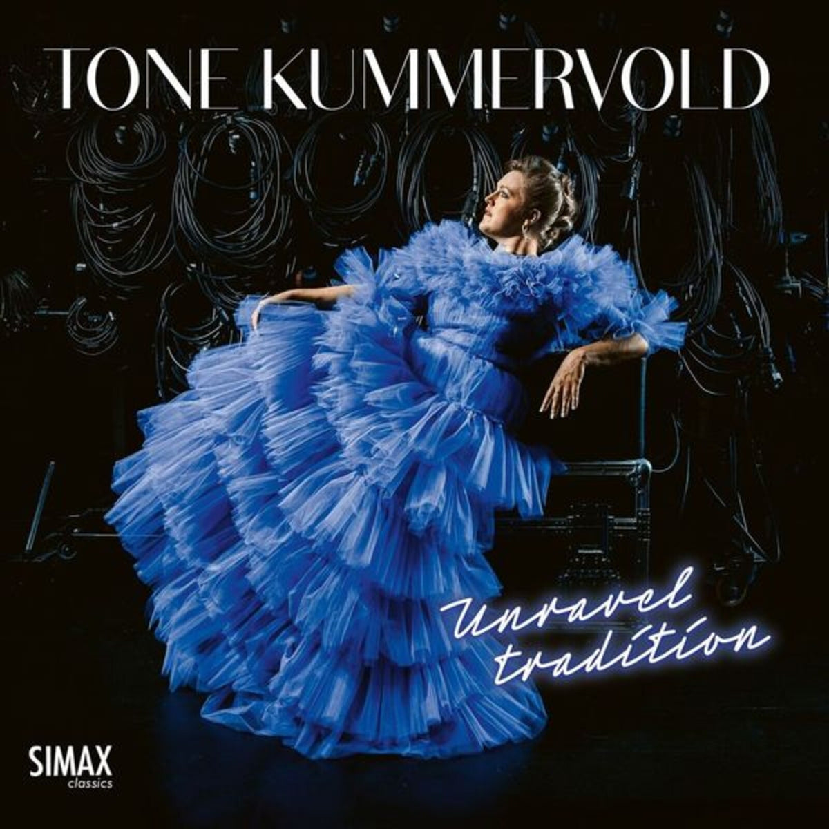 CD cover: woman in voluminous blue dress, titled "Unravel Tradition".