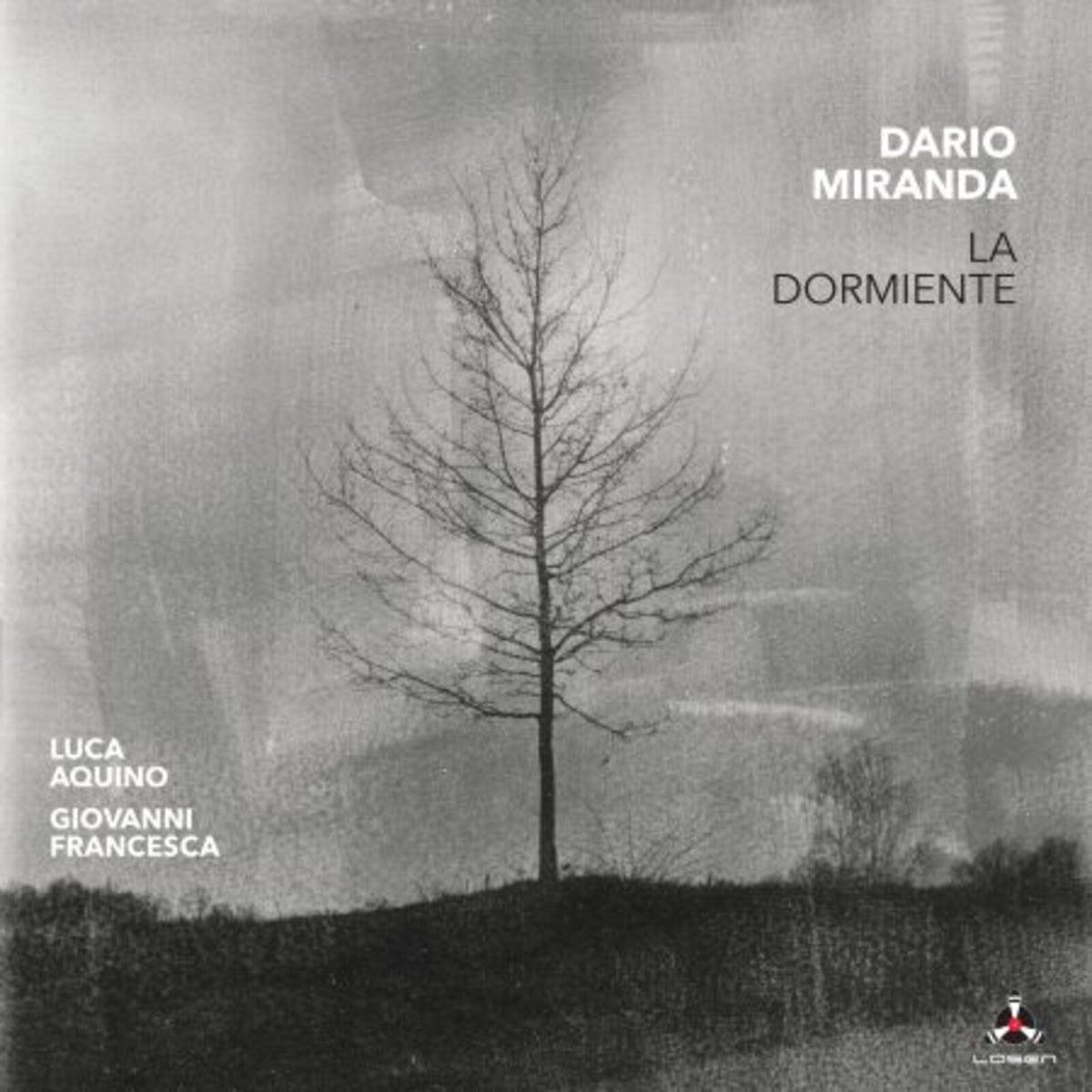 Black and white album cover featuring a solitary, bare tree on a hill.