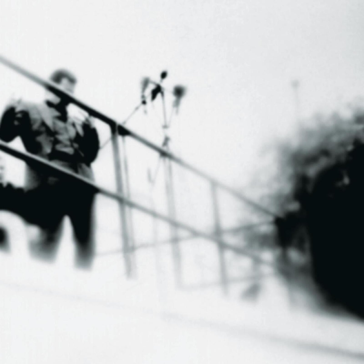 Blurred black and white image of a person with a microphone.