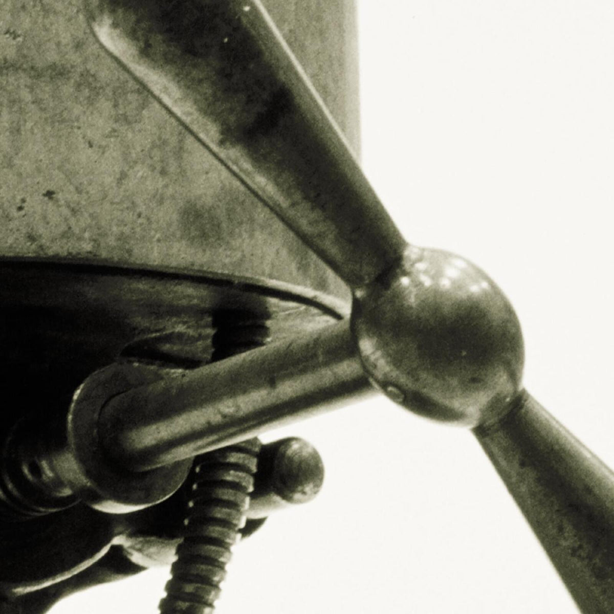 Close-up of a propeller connected to a metallic structure, monochrome.