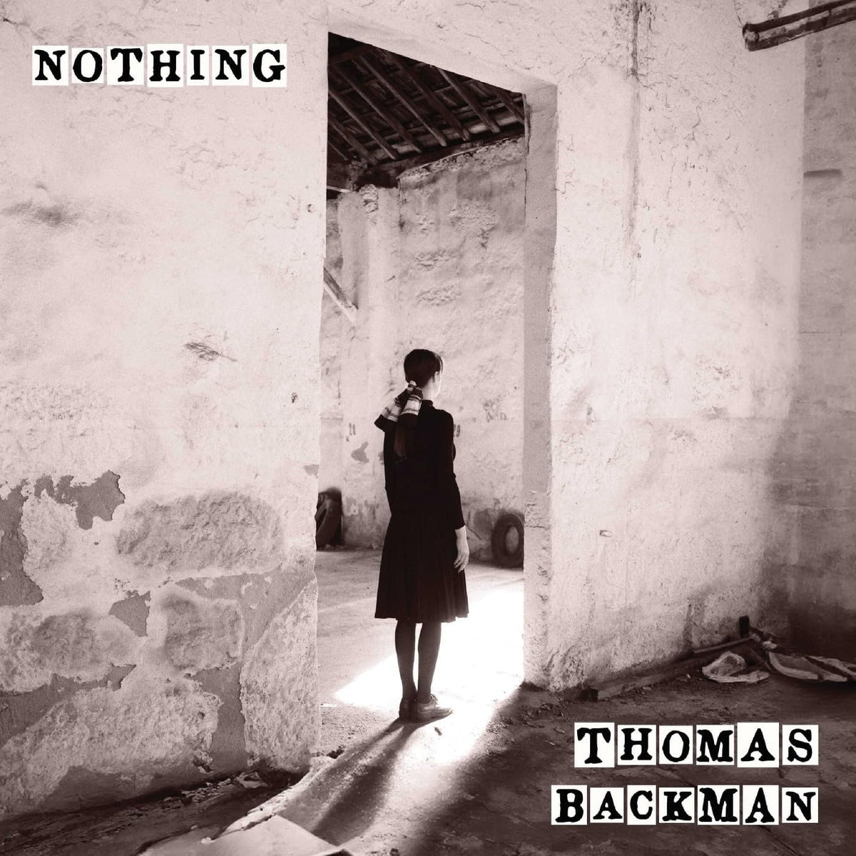 Black and white album cover featuring a person in a doorway.