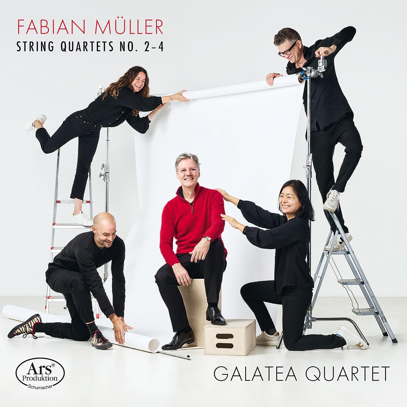 Galatea Quartet posing with ladders and music rolls in a studio.