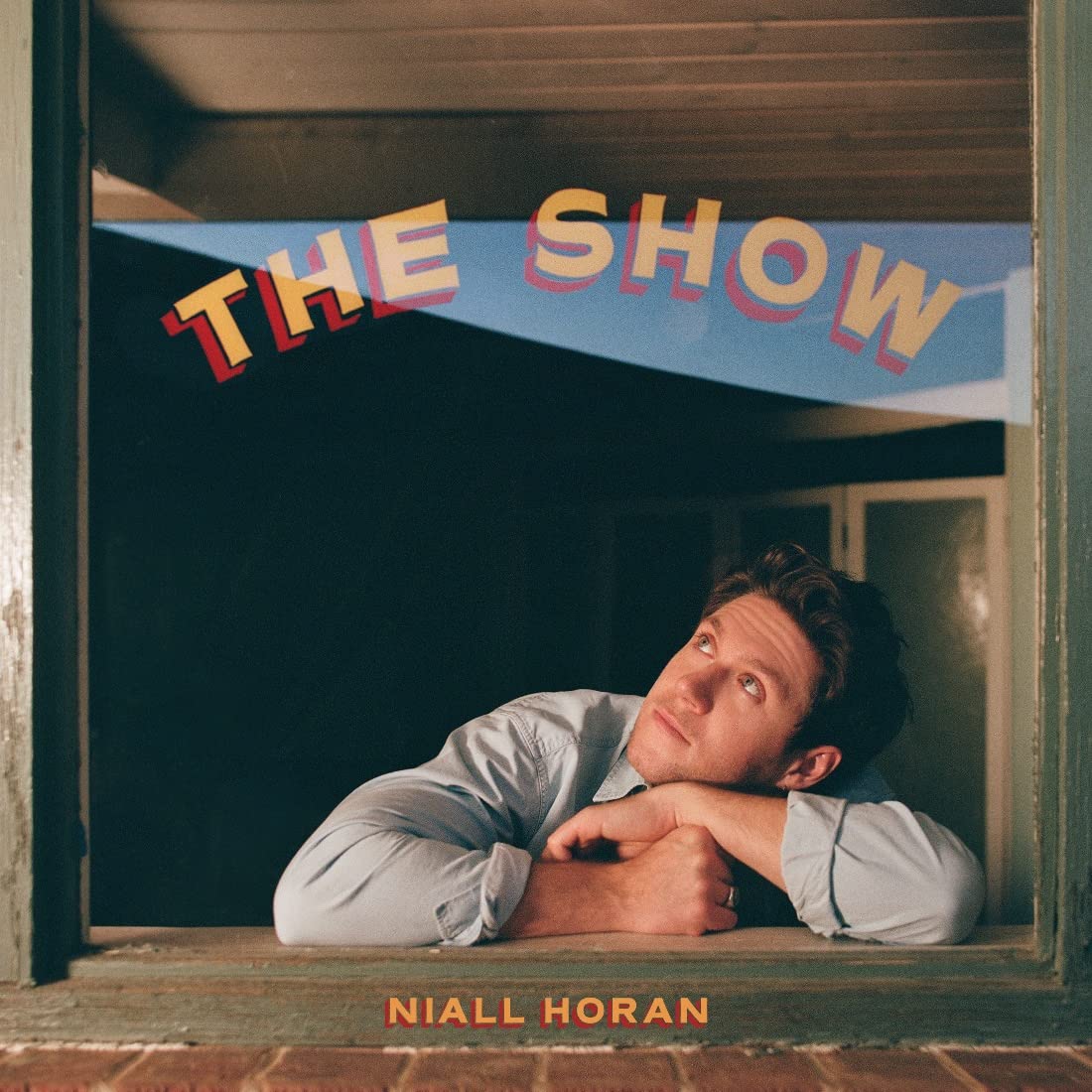 Niall Horan album cover, looking out a window with red text.