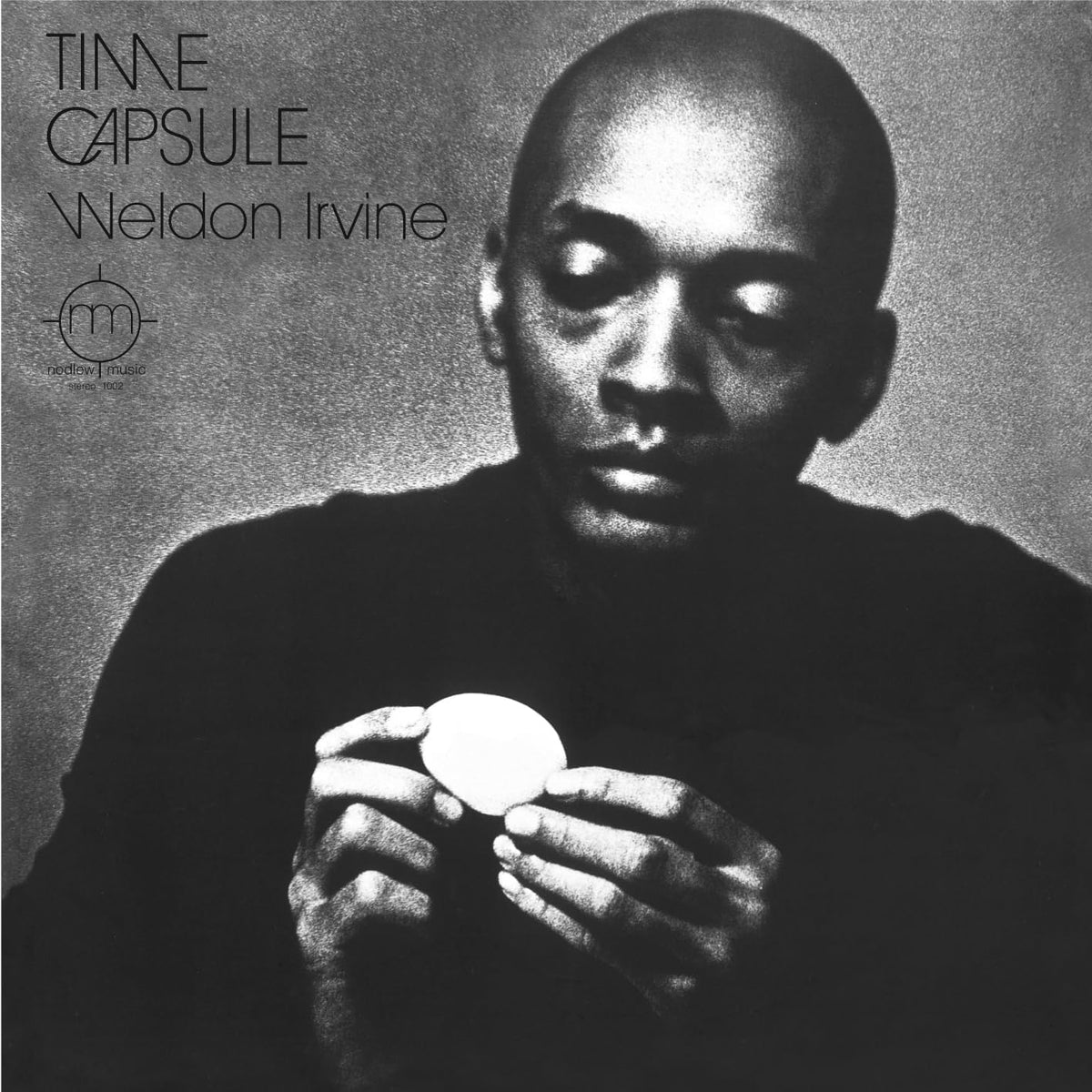Black and white album cover featuring Weldon Irvine holding an egg.