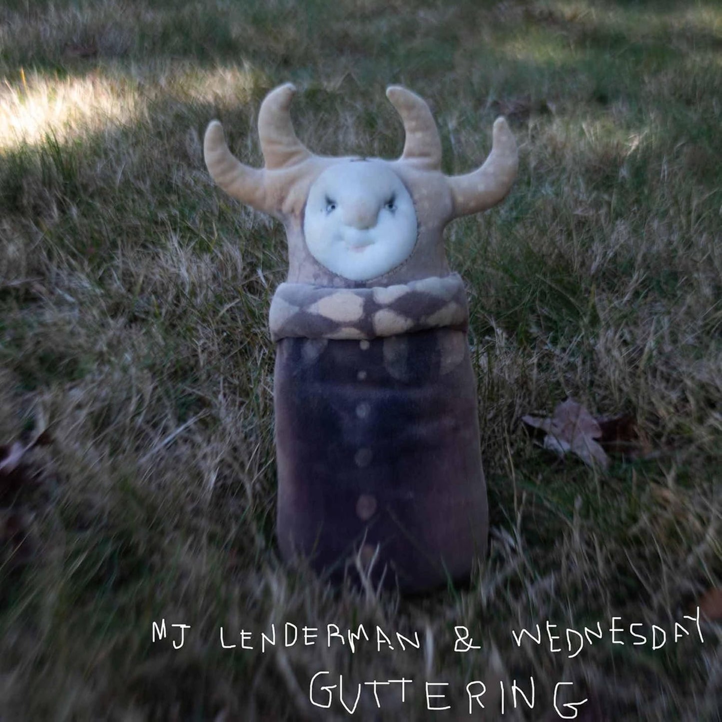 Vinyl record cover featuring a plush, horned creature in grass.