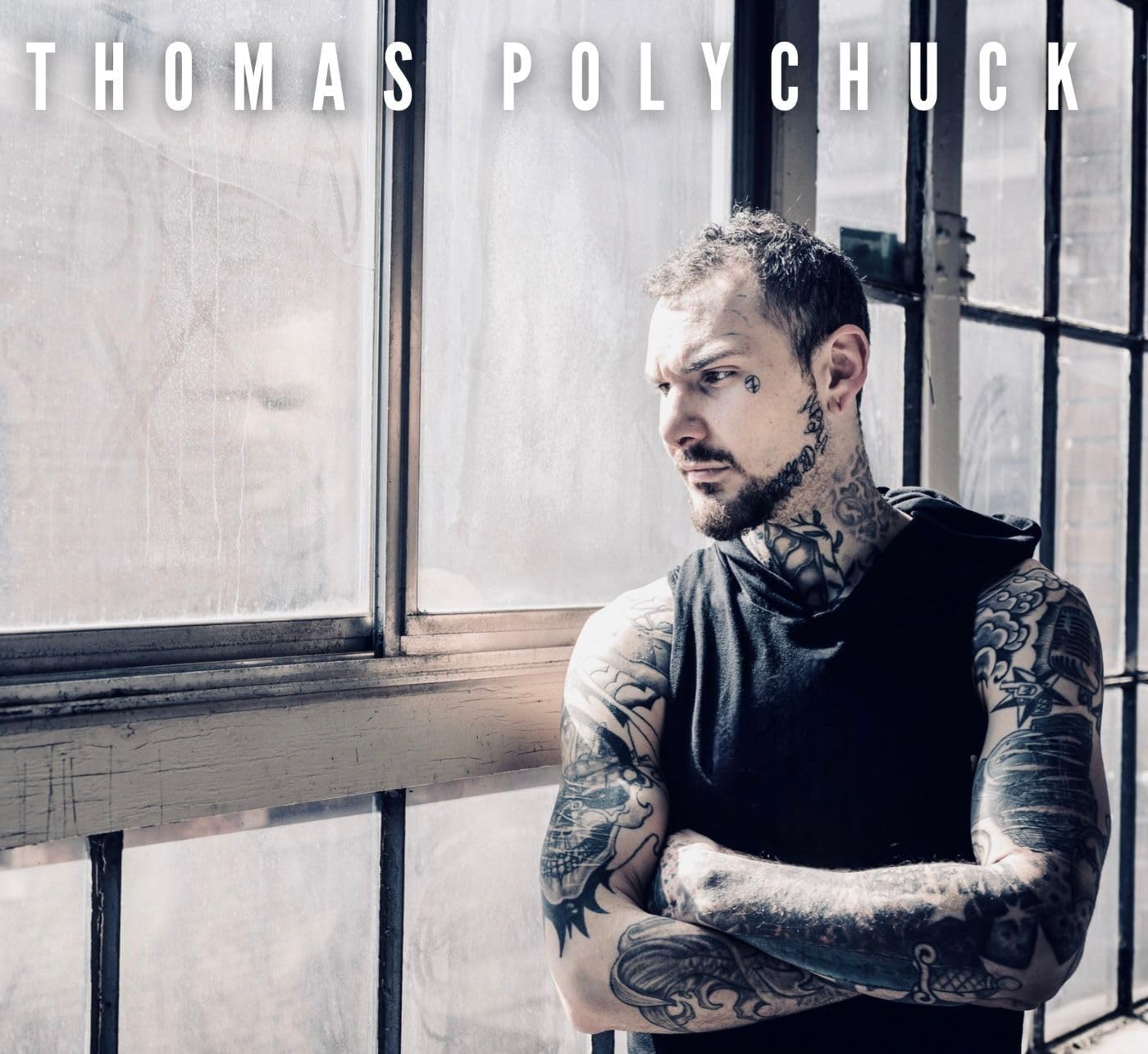 CD cover featuring a portrait of Thomas Polychuck with tattoos.