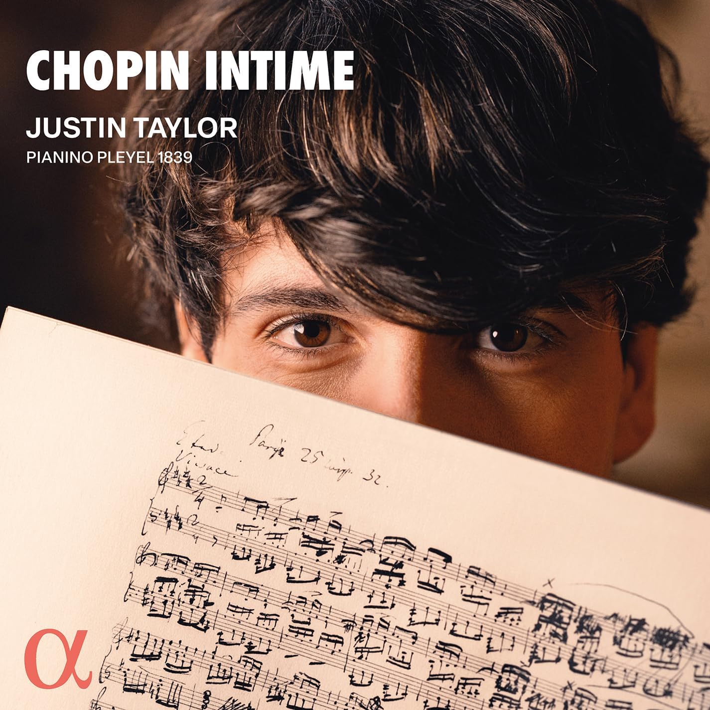 CD cover: pianist Justin Taylor holding handwritten sheet music.