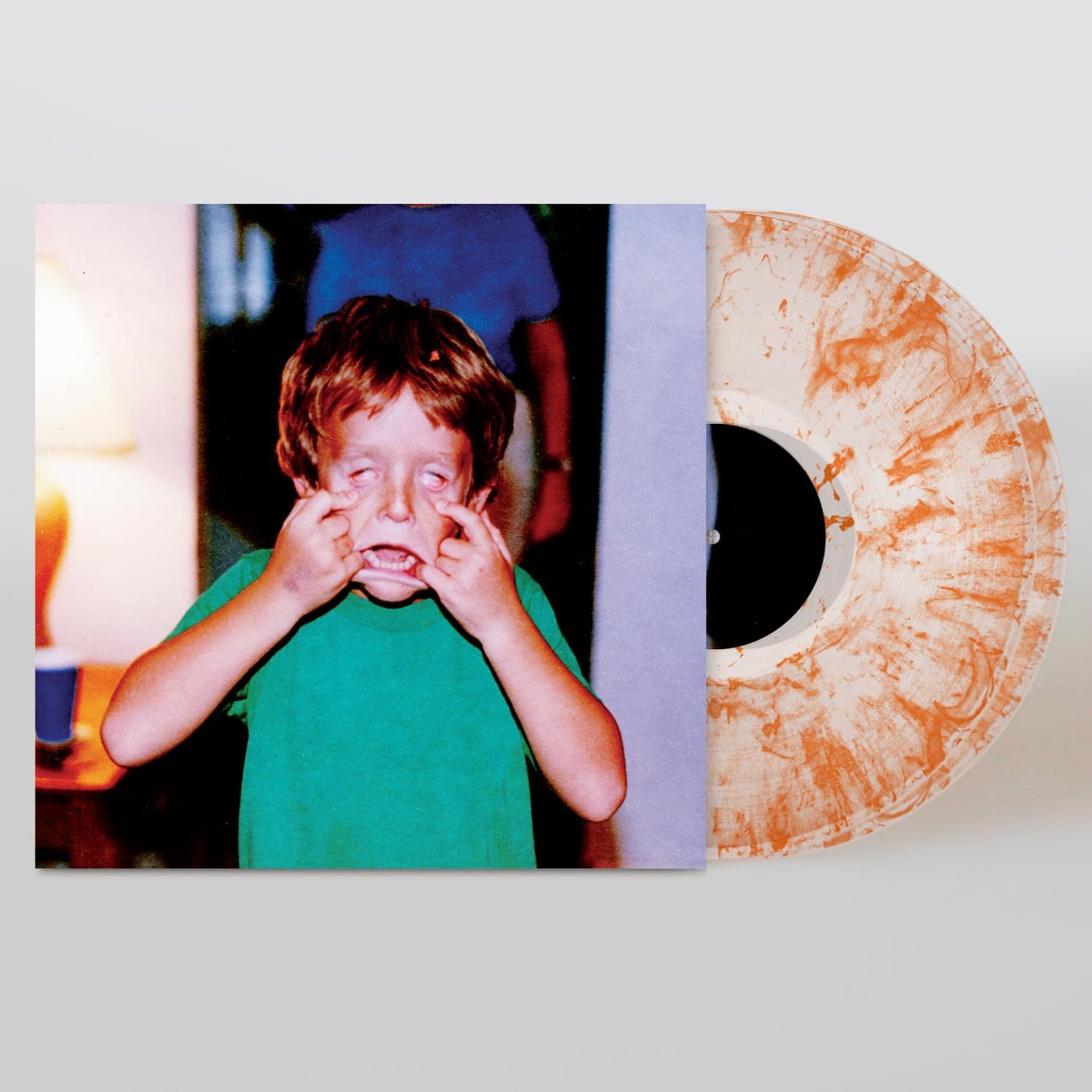 Vinyl record with cover showing a crying child and abstract patterns.