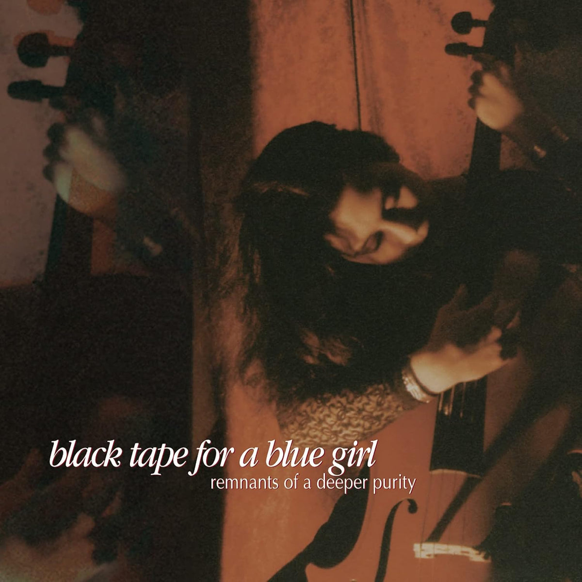 Dark, grainy album cover featuring a person with a violin and reflection.