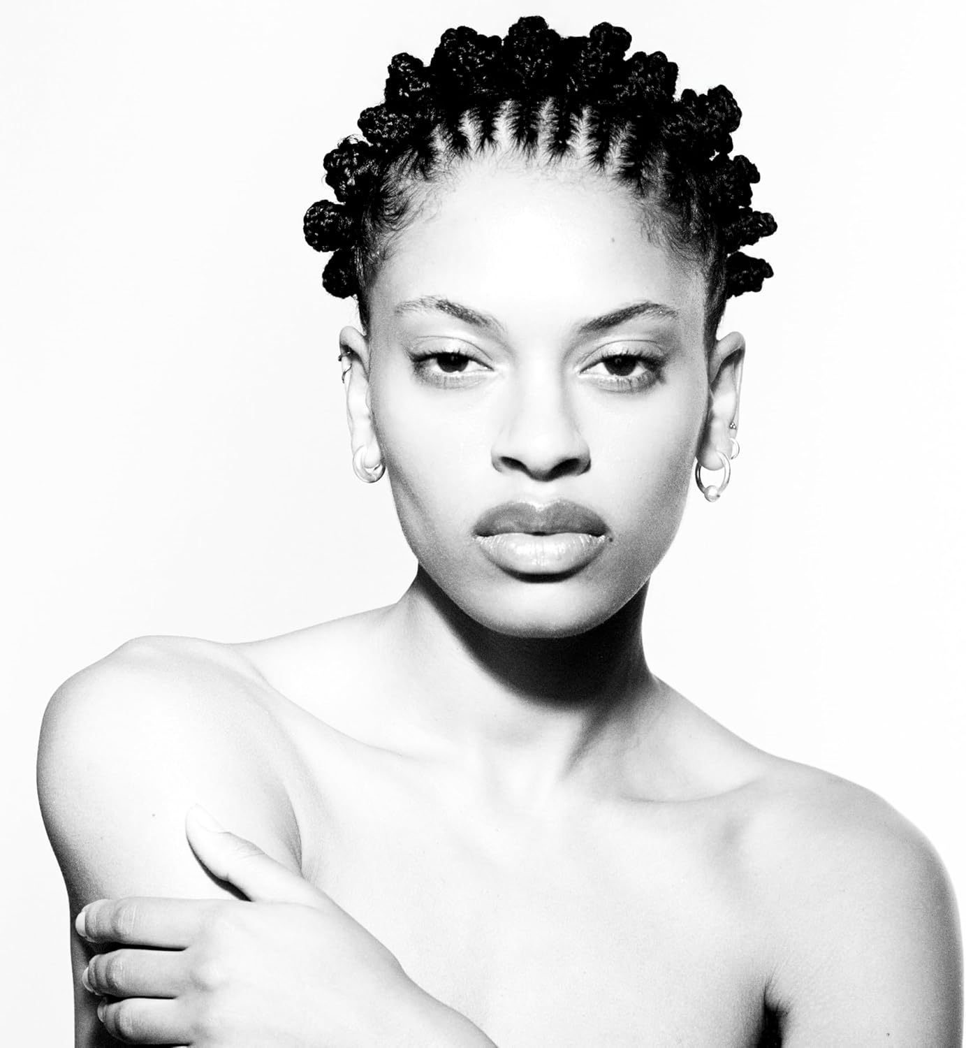 Black and white portrait of Annahstasia with braided hair and direct gaze.