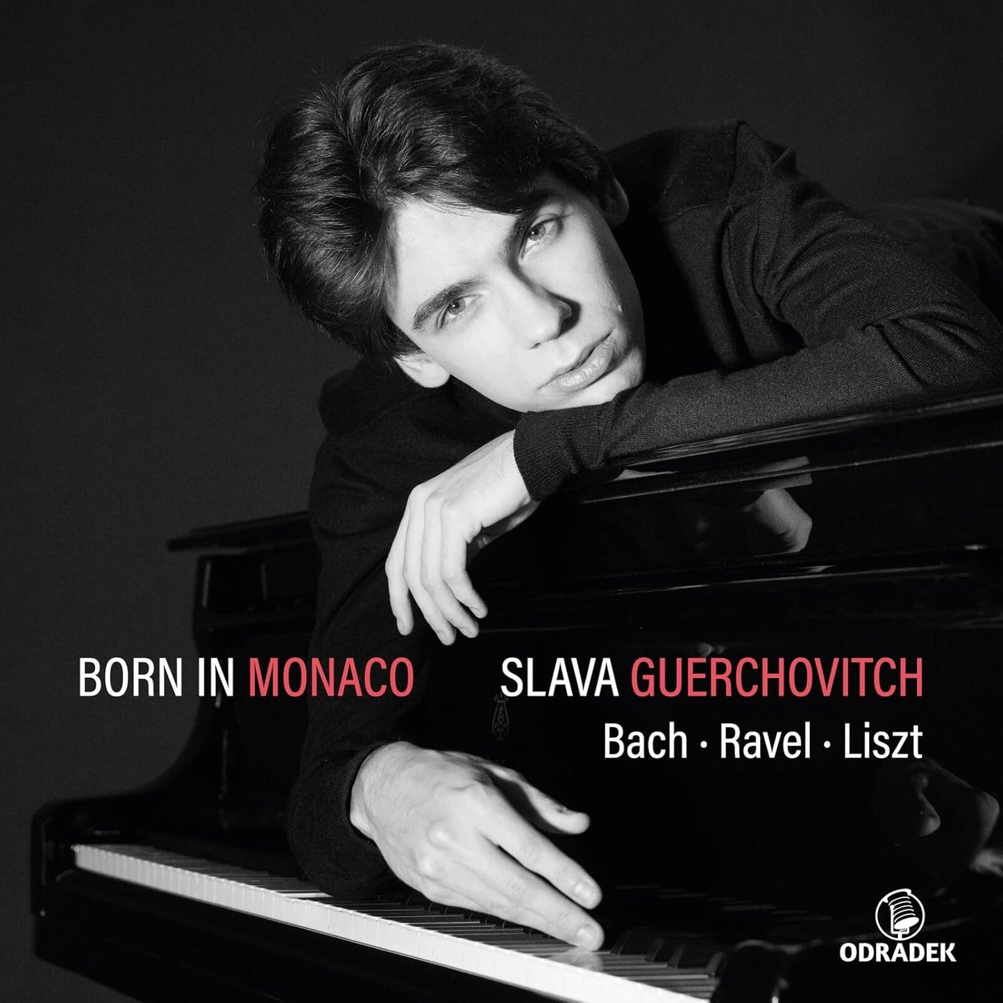 Black and white portrait of pianist Slava Guerchovitch at a piano.